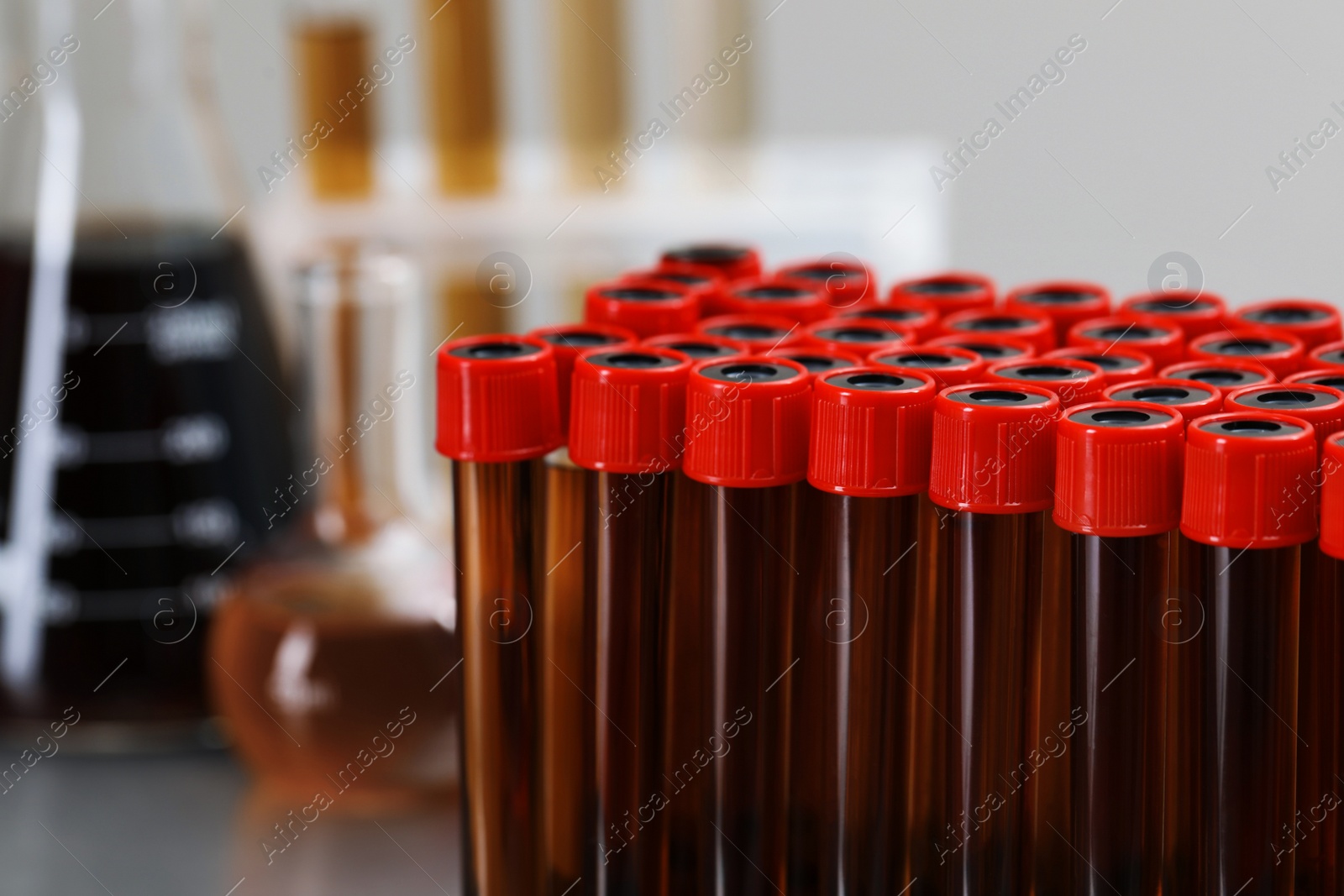 Photo of Test tubes with brown liquid, closeup view