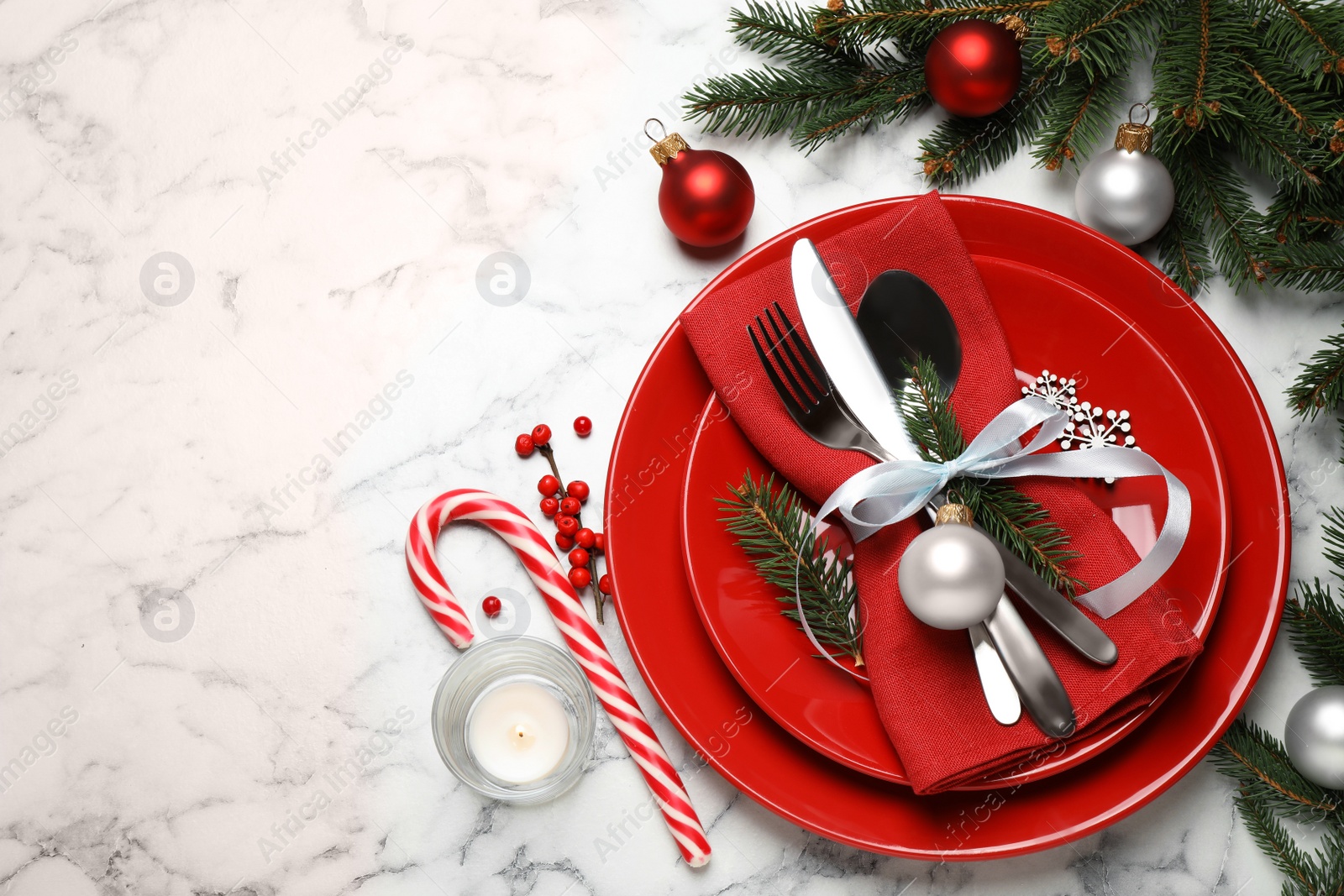 Photo of Festive table setting with beautiful dishware and Christmas decor on white marble background, flat lay. Space for text