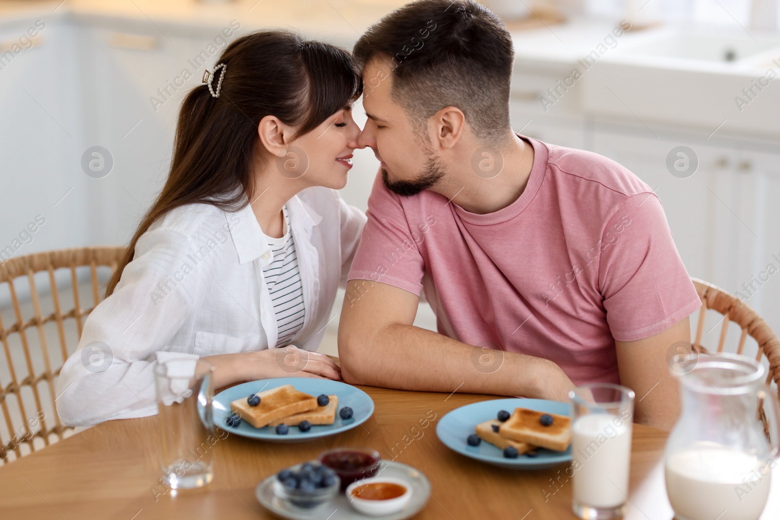 Photo of Lovely couple spending time together during breakfast at home