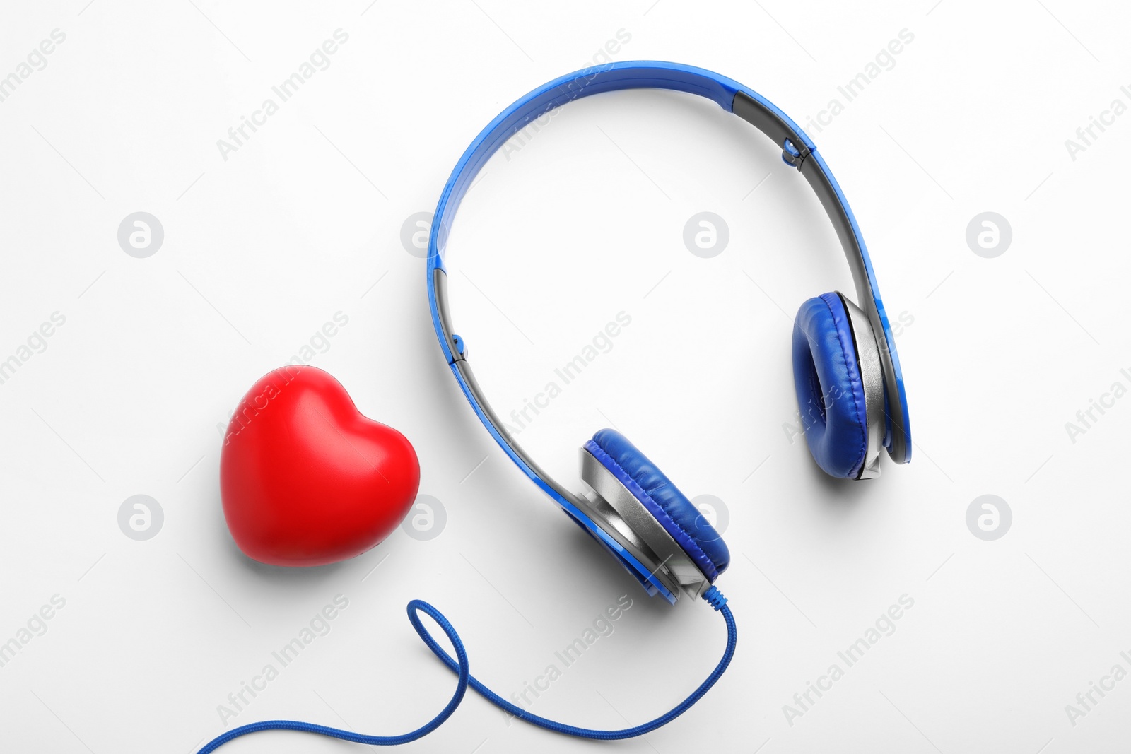 Photo of Decorative heart and modern headphones on white background, top view