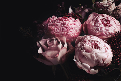 Photo of Beautiful bouquet of different flowers on black background, closeup. Floral card design with dark vintage effect