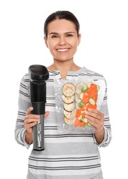 Photo of Beautiful young woman holding sous vide cooker and vegetables in vacuum packs on white background
