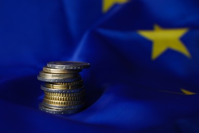 Photo of Stack of coins on European Union flag, space for text
