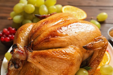 Photo of Platter of cooked turkey with garnish on table, closeup