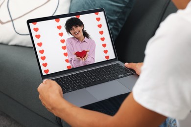 Image of Long distance love. Man having video chat with his girlfriend via laptop at home, closeup