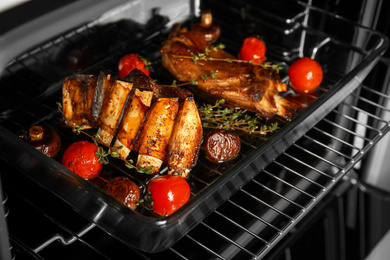 Photo of Delicious roasted ribs in oven. Yummy meat