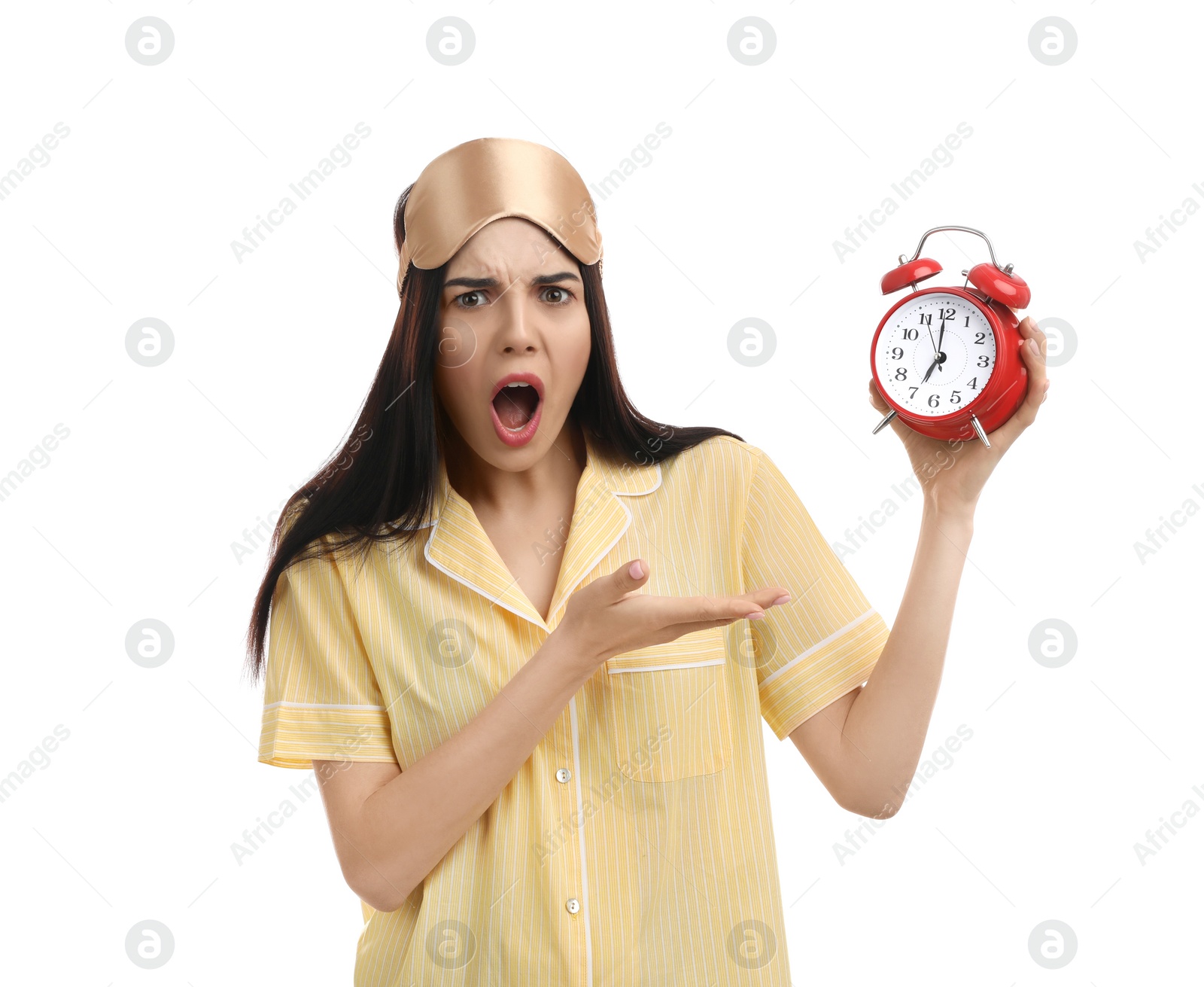 Photo of Emotional overslept woman with alarm clock on white background. Being late concept