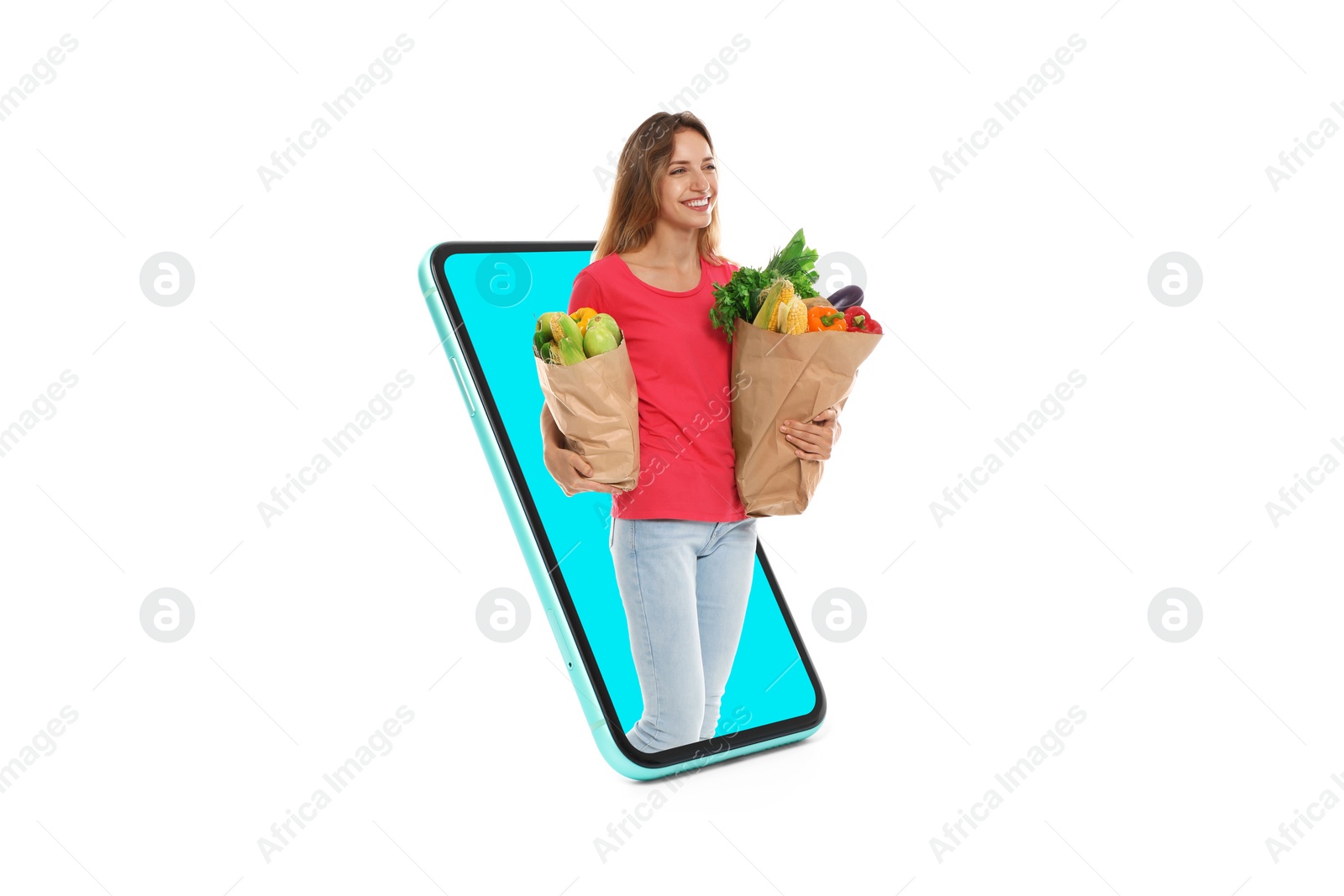 Image of Grocery shopping via internet. Happy woman with bags full of products walking out of huge smartphone on white background