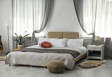Photo of Stylish modern bedroom with decorative elements. Idea for interior design