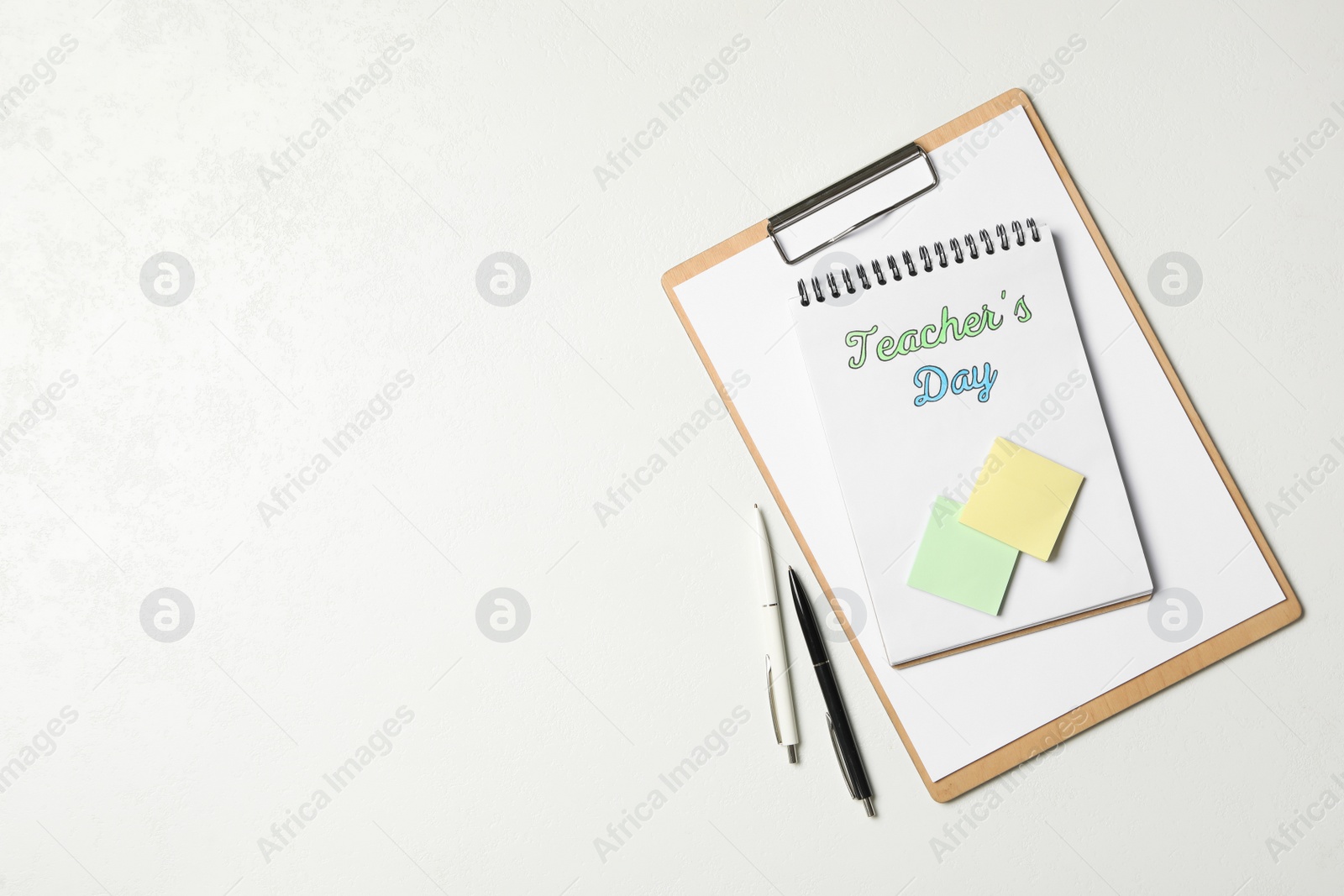 Photo of Stationery and words TEACHER'S DAY on white background, flat lay. Space for text