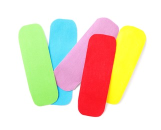 Bright kinesio tape pieces on white background, top view