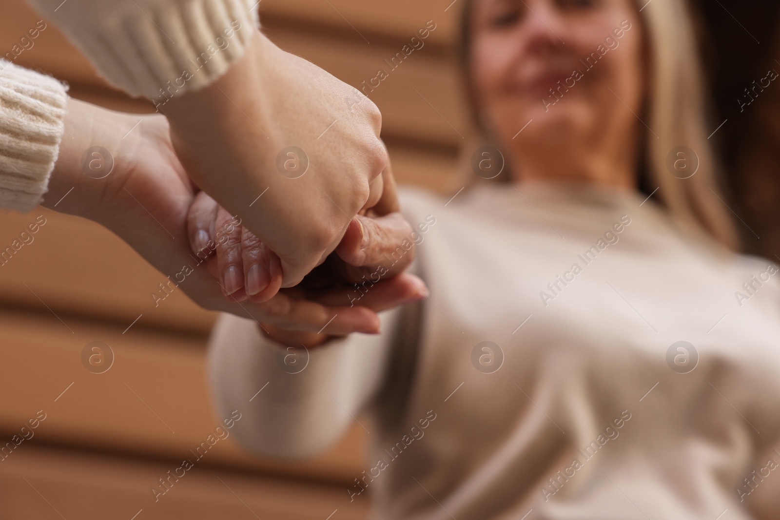 Photo of Trust and support. Women joining hands outdoors, low angle view