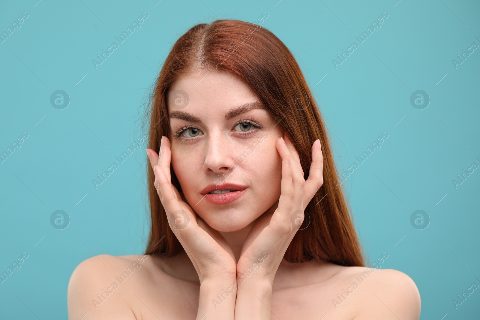 Photo of Portrait of beautiful woman with freckles on light blue background