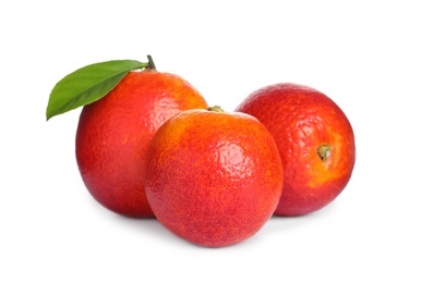 Photo of Whole ripe red oranges with green leaf on white background