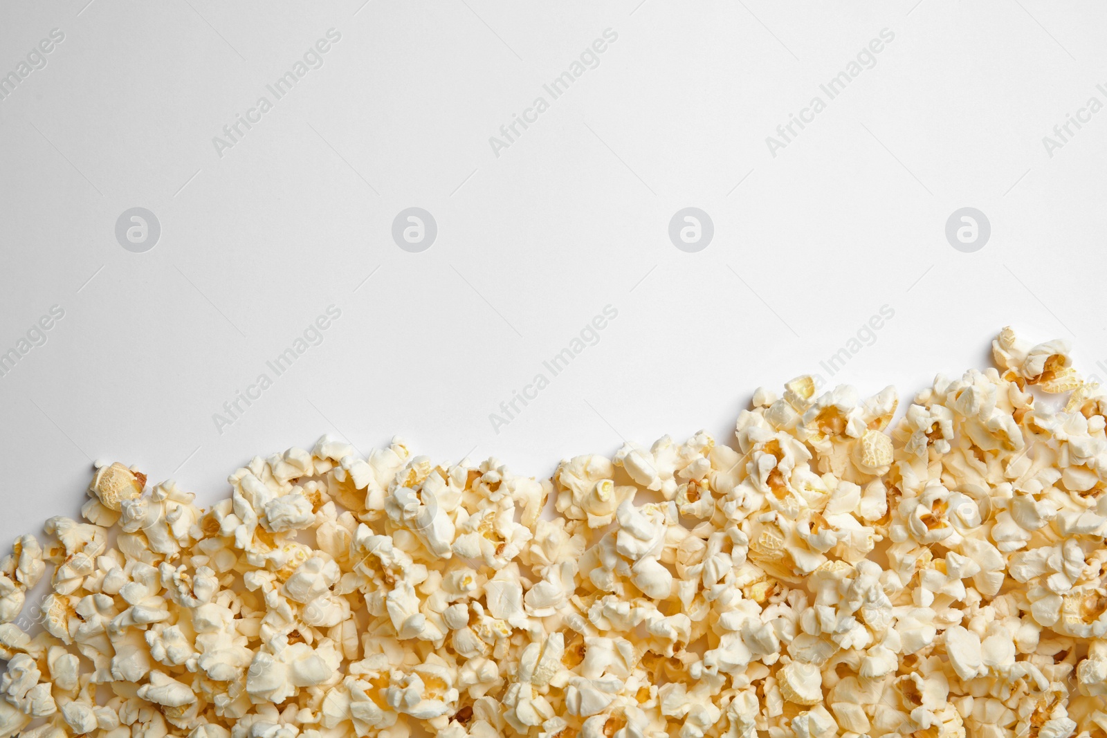 Photo of Delicious fresh popcorn on white background, top view