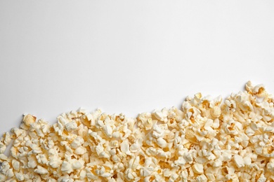 Delicious fresh popcorn on white background, top view