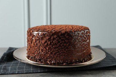 Photo of Delicious chocolate truffle cake on grey textured table