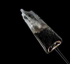 Photo of Glass of champagne on black background. Festive drink