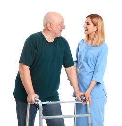 Photo of Caretaker helping elderly man with walking frame on white background