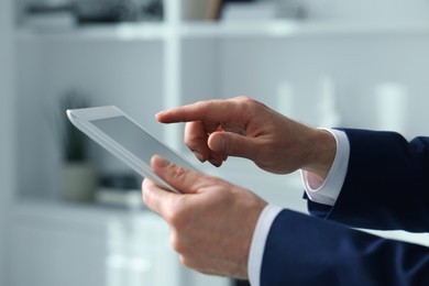 Closeup view of man using new tablet indoors