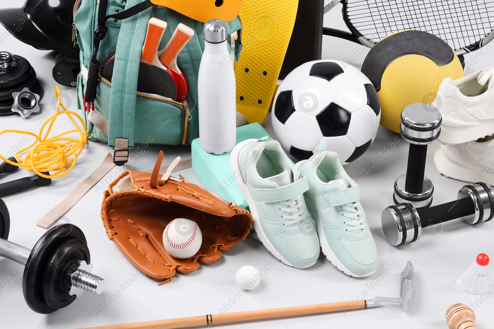 Photo of Many different sports equipment on light grey background