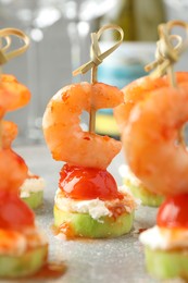 Photo of Tasty canapes with shrimps, vegetables and cream cheese on table, closeup