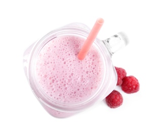 Photo of Tasty raspberry milk shake in mason jar and fresh berries isolated on white, top view