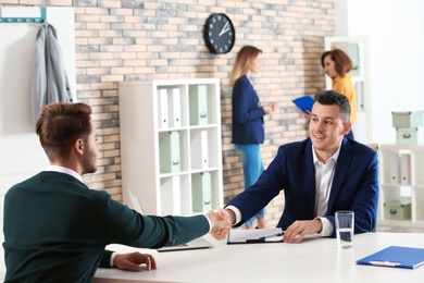 Human resources manager conducting job interview with applicant in office