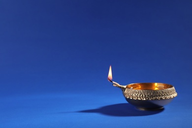 Photo of Diwali diya or clay lamp on color background