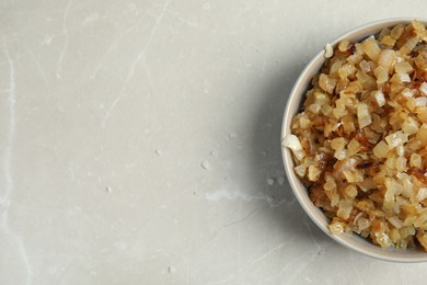 Photo of Tasty fried onion on grey marble table, top view. Space for text