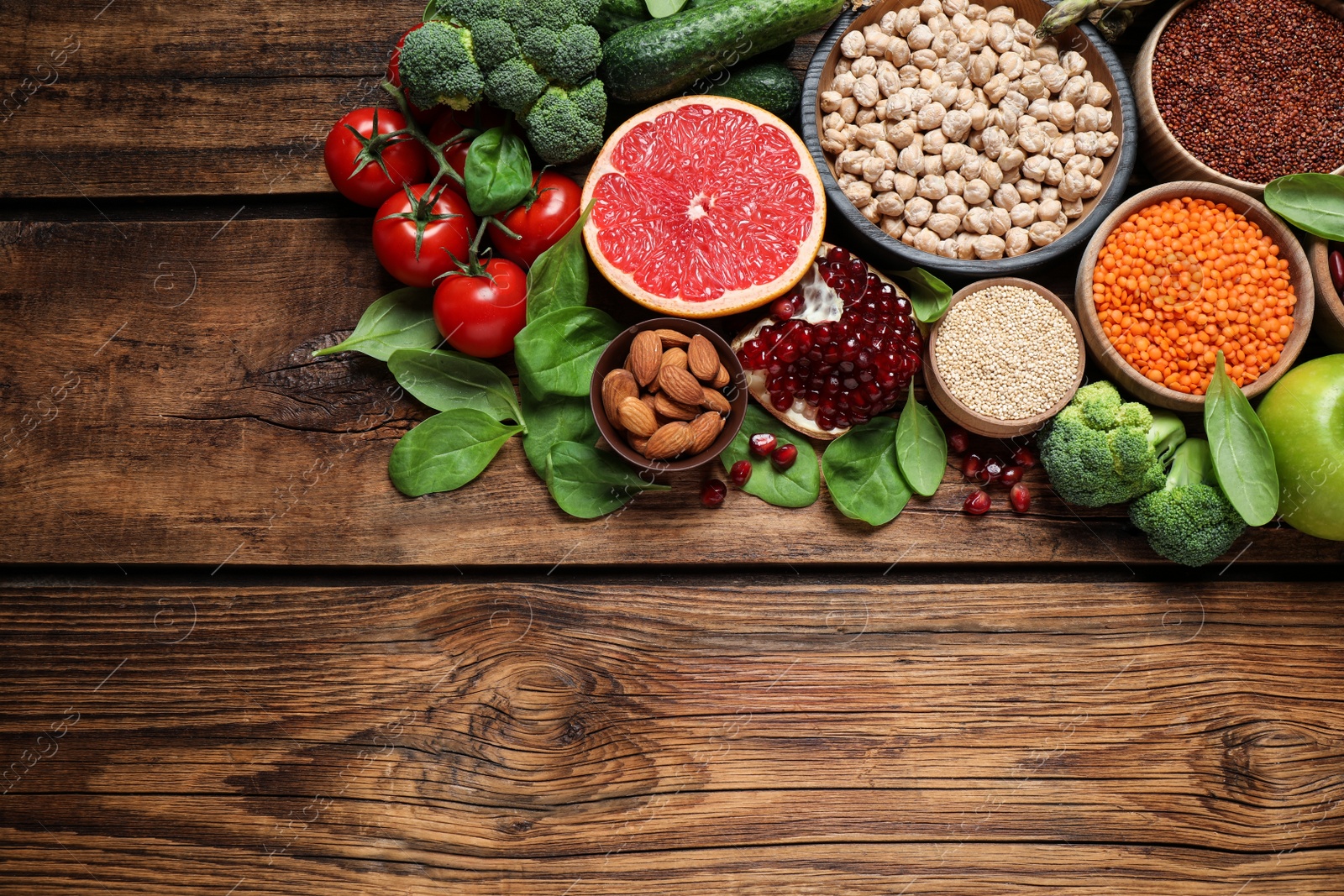 Photo of Fresh vegetables, fruits and seeds on wooden table, above view. Space for text