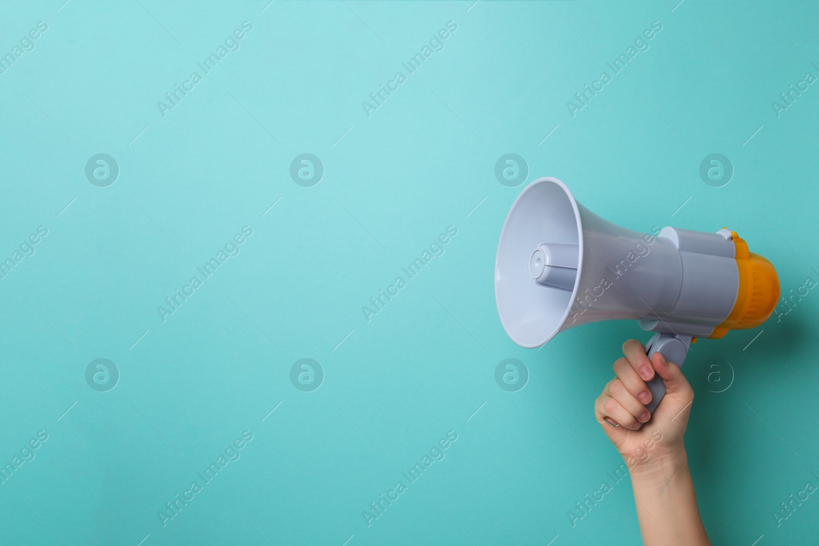 Photo of Man holding megaphone on color background