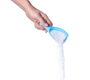 Photo of Woman pouring laundry detergent from measuring container against white background, closeup