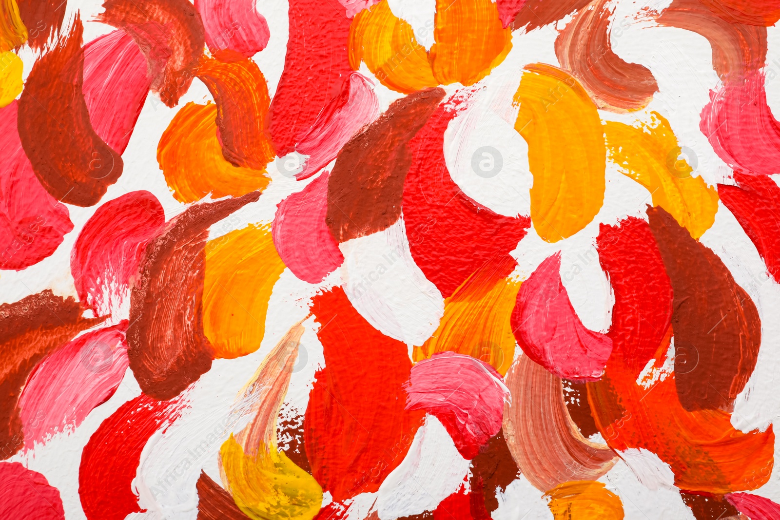 Photo of Beautiful strokes of bright oil paints on white canvas as background, closeup