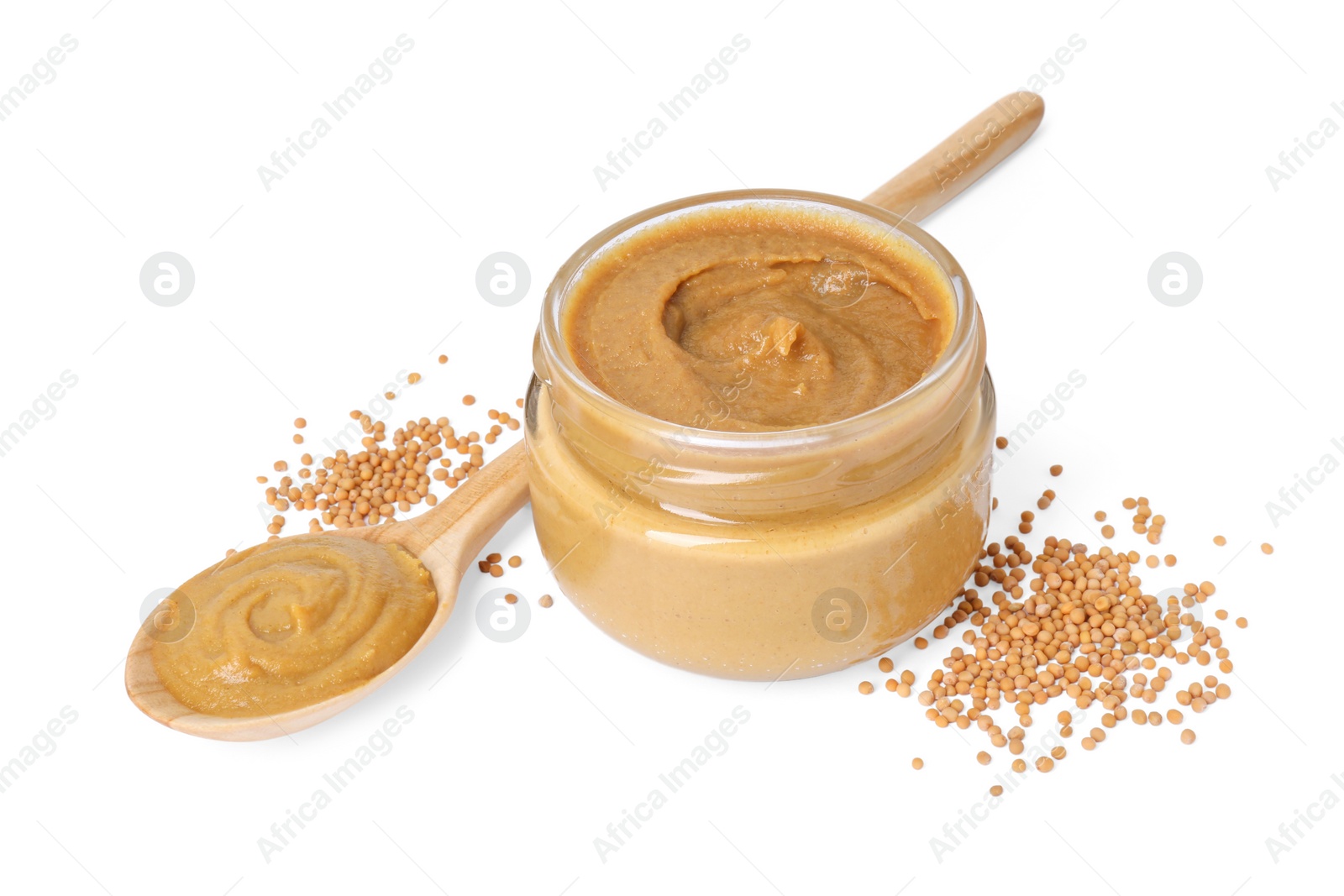 Photo of Fresh tasty mustard sauce in jar, spoon and dry seeds isolated on white