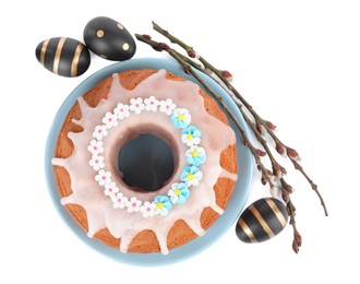 Photo of Festively decorated Easter cake, painted eggs and pussy willow branches on white background, top view