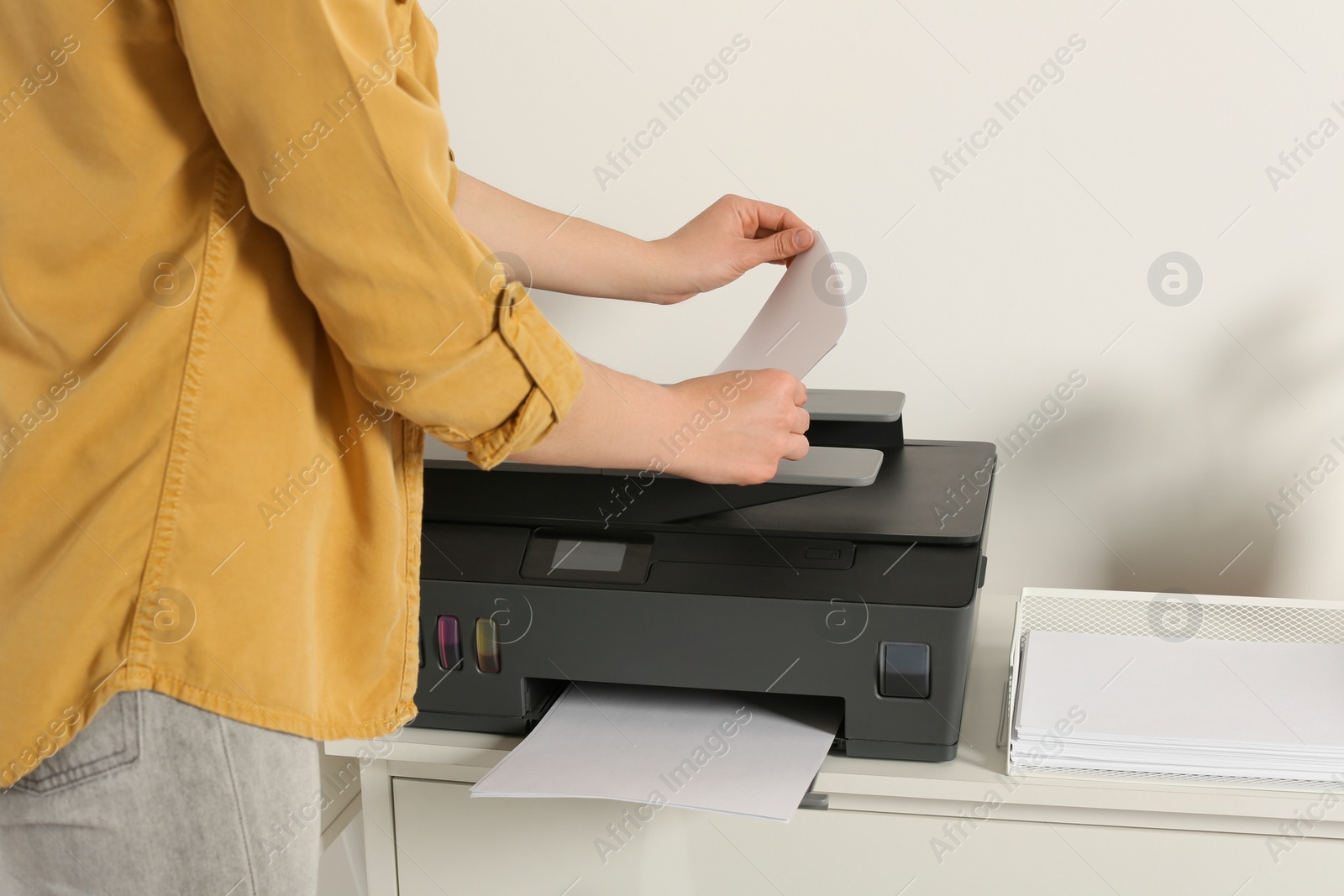 Photo of Woman using modern printer at home, closeup