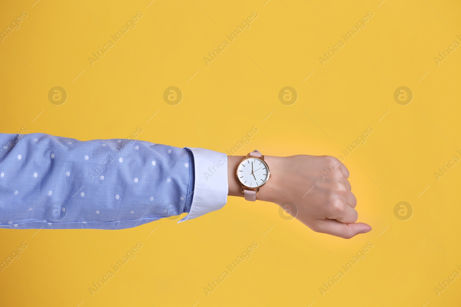 Photo of Young woman with wristwatch on color background. Time concept