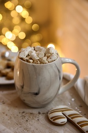 Photo of Tasty hot drink with marshmallows on table. Christmas atmosphere