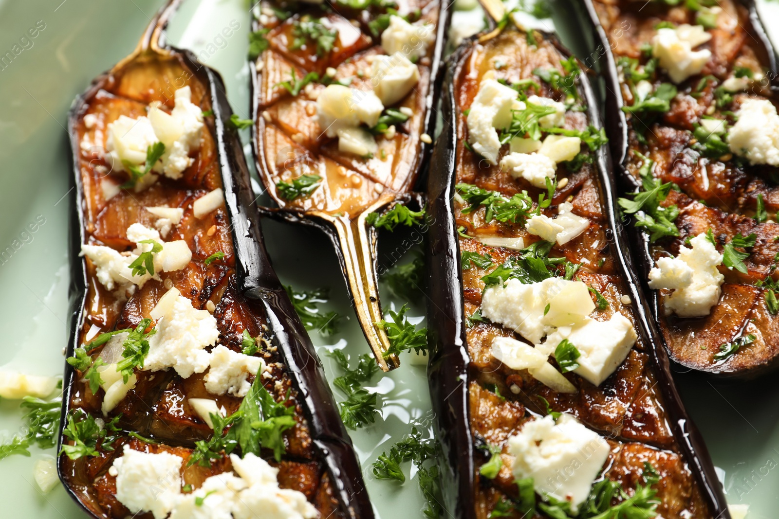 Photo of Fried eggplant slices with cheese on light background, closeup