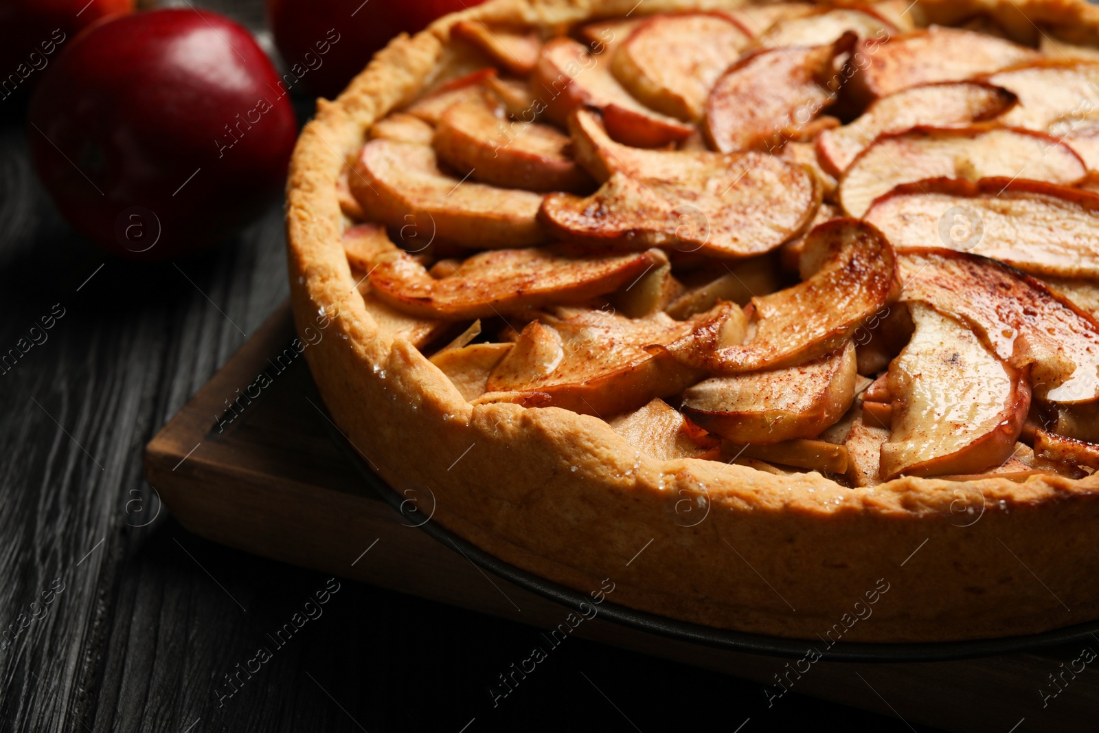 Photo of Delicious apple pie and fresh fruits on black wooden table, closeup