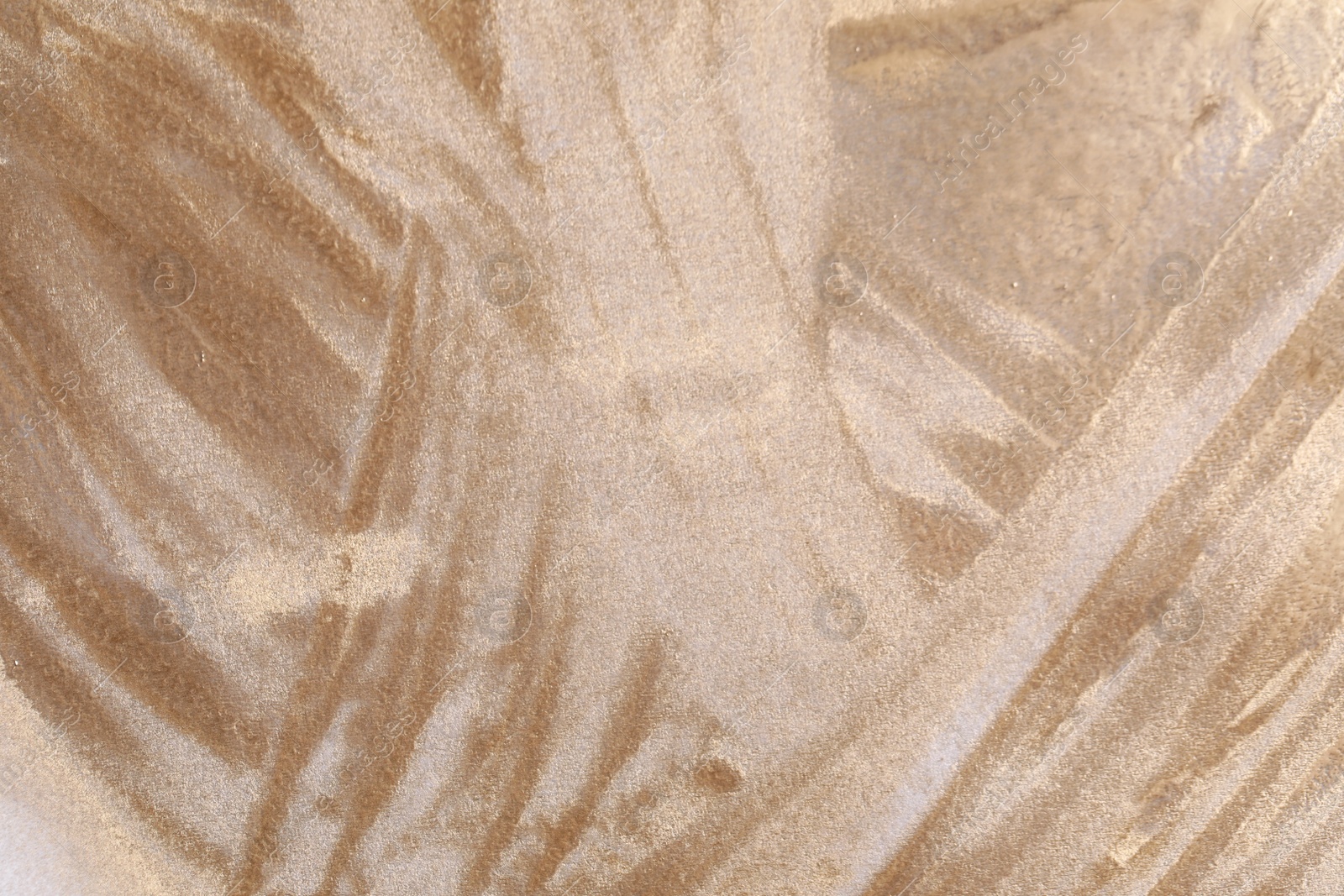 Photo of Texture of golden spray paint as background, top view