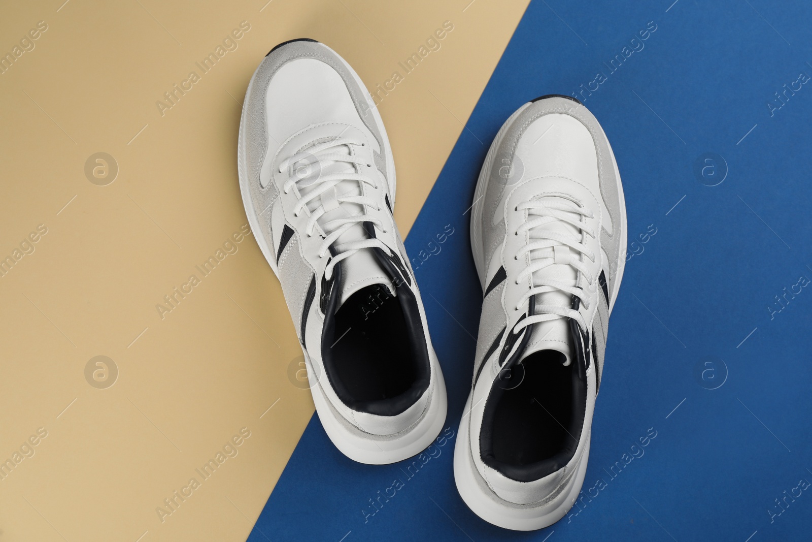 Photo of Pair of stylish sneakers on color background, flat lay