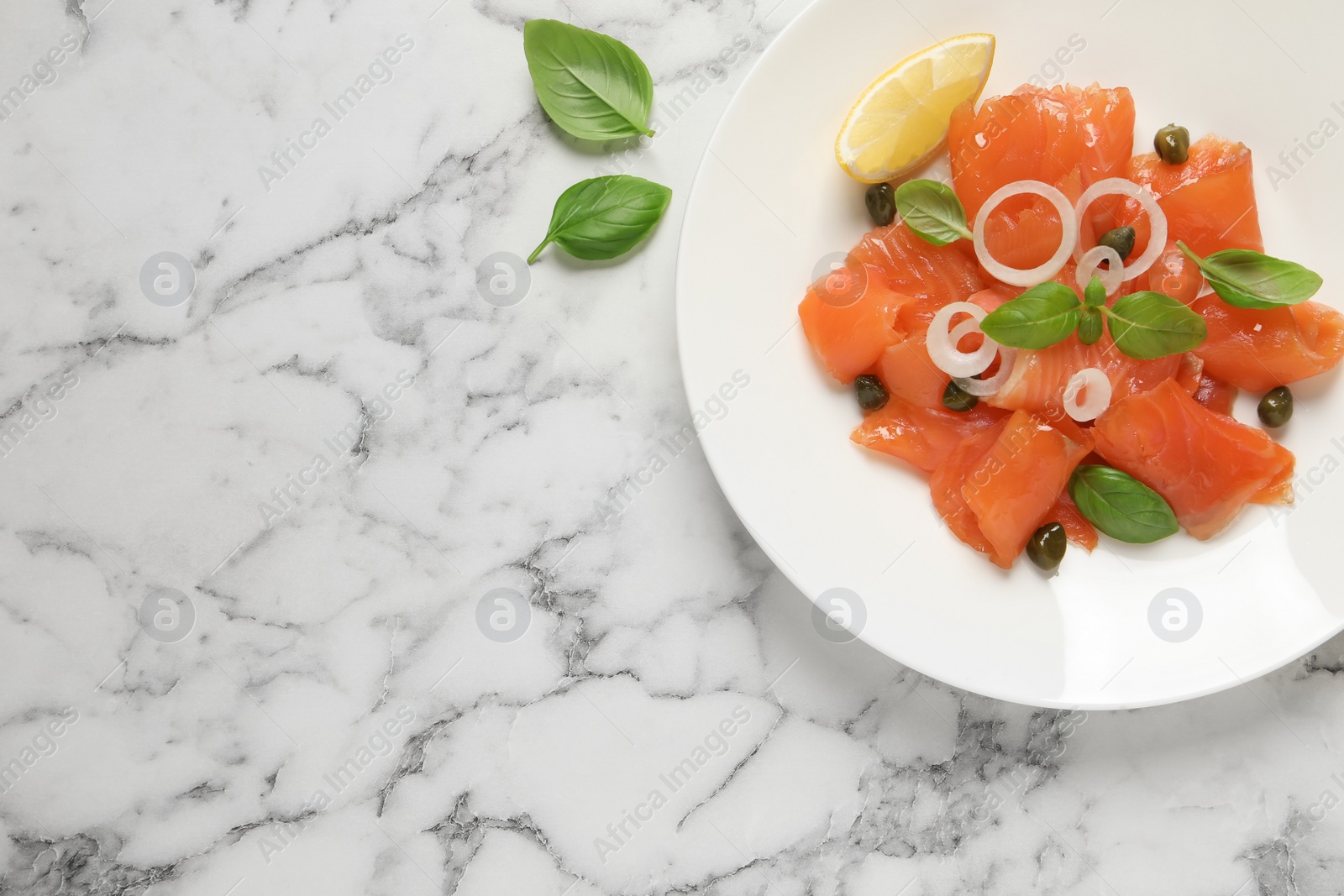 Photo of Delicious salmon carpaccio served on white marble table, flat lay. Space for text