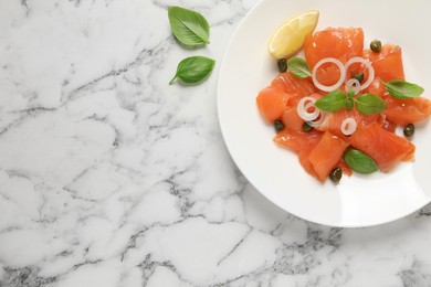 Delicious salmon carpaccio served on white marble table, flat lay. Space for text