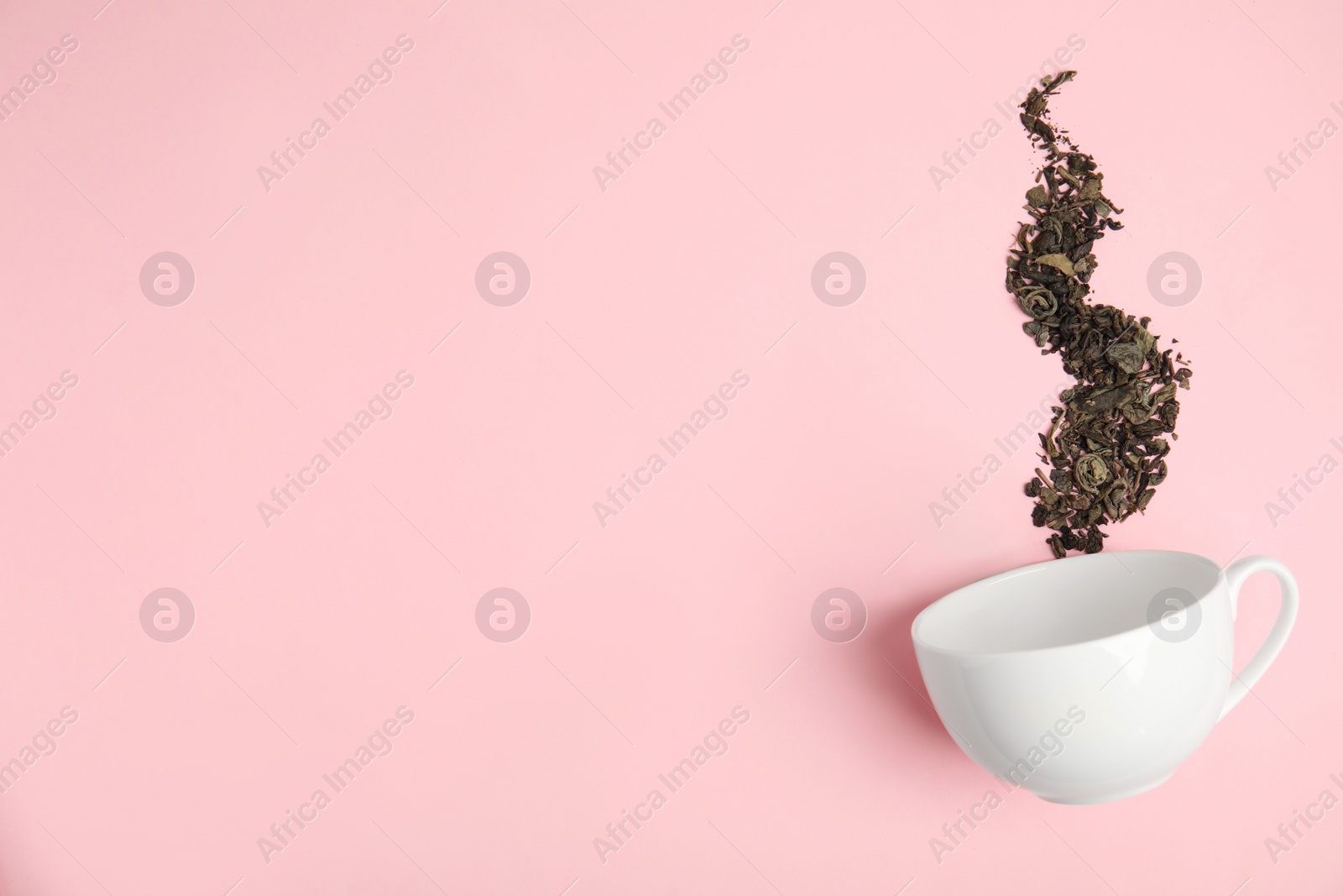 Photo of Dry tea brew and cup on pink background, flat lay. Space for text