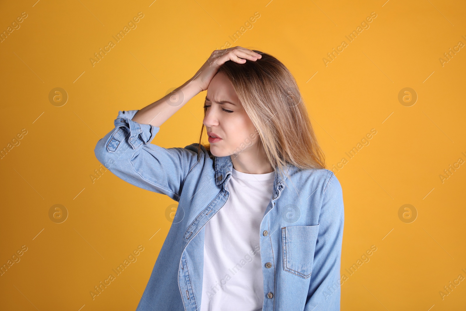 Photo of Portrait of stressed young woman on yellow background