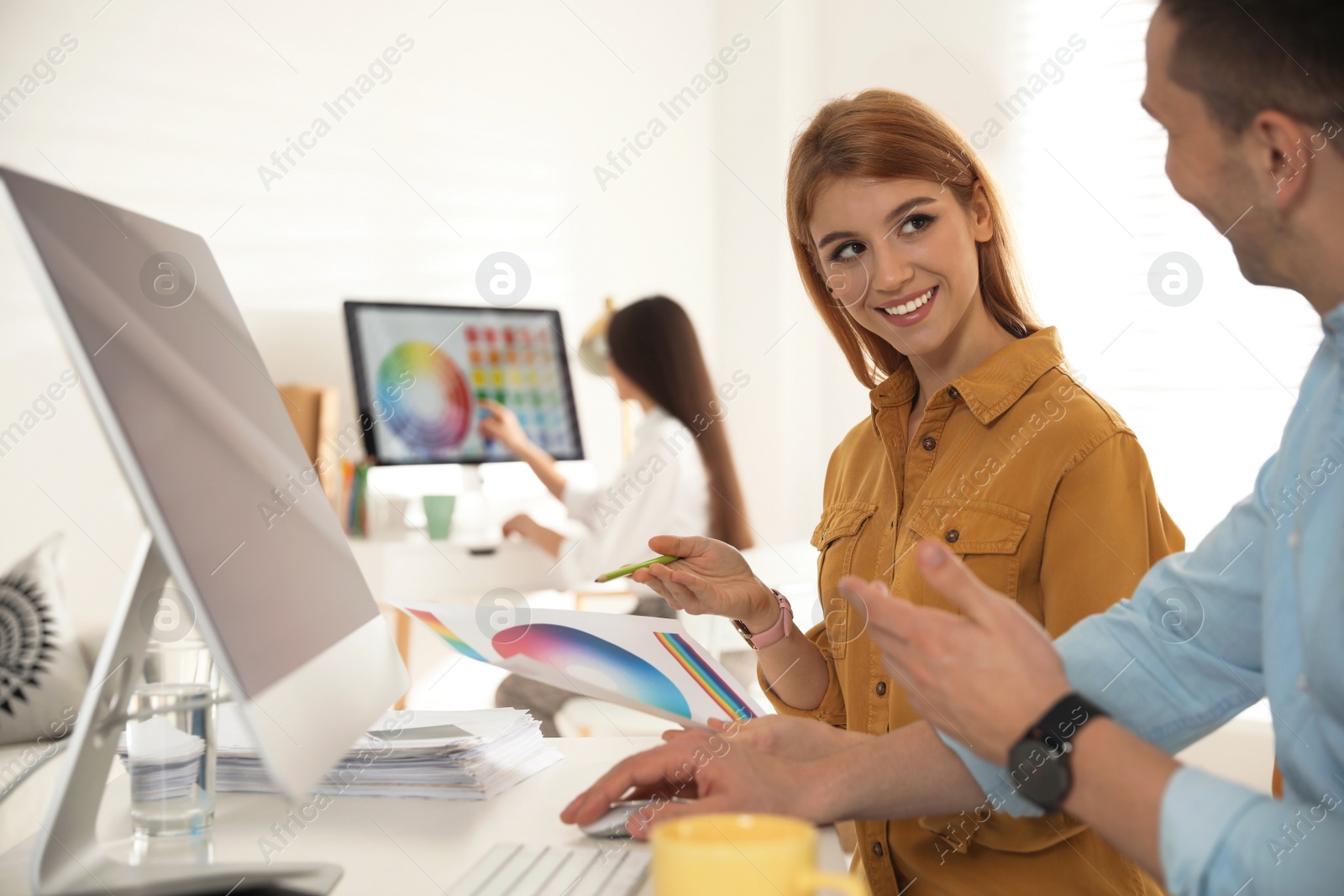 Photo of Professional designers working together in modern office