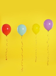 Photo of Bright balloons on color background. Celebration time