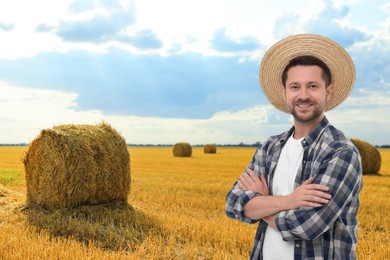 Image of Confident farmer with crossed arms in field. Harvesting season